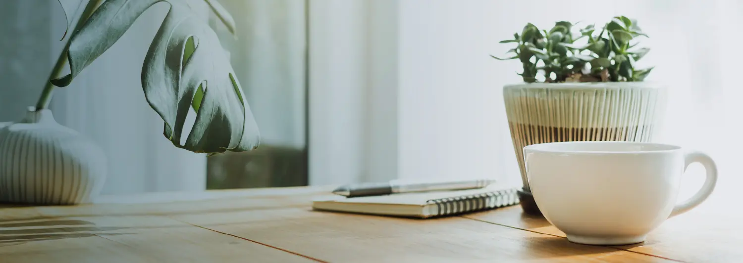 Desk with notebook and coffee cup